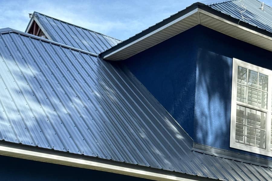 Home with an exposed fastener metal roof