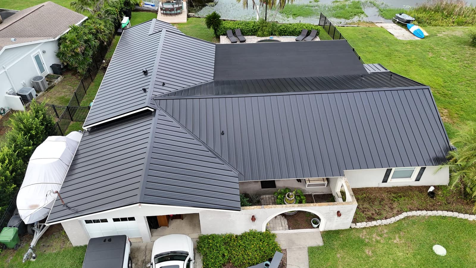 Aerial view of a home with a new black standing seam metal roof